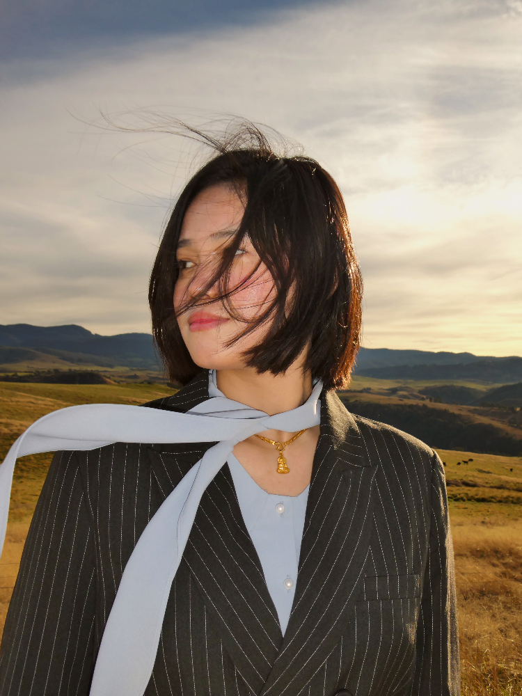 Sonika in a pinstripe blazer at golden hour
