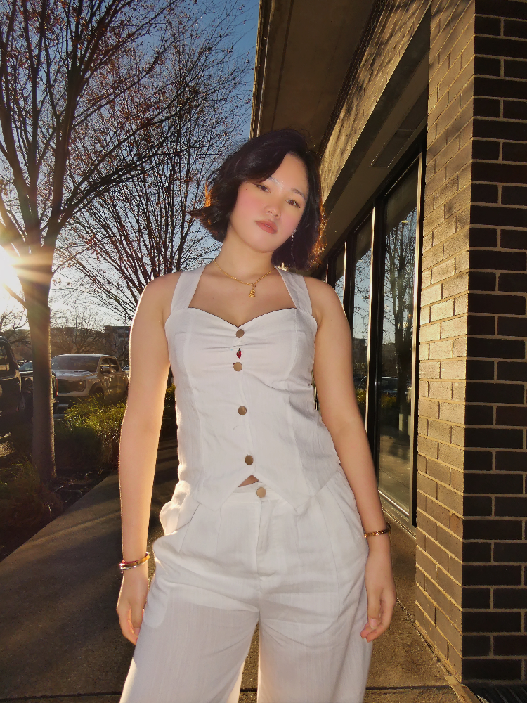 Sonika in a white linen set on a sunlit street